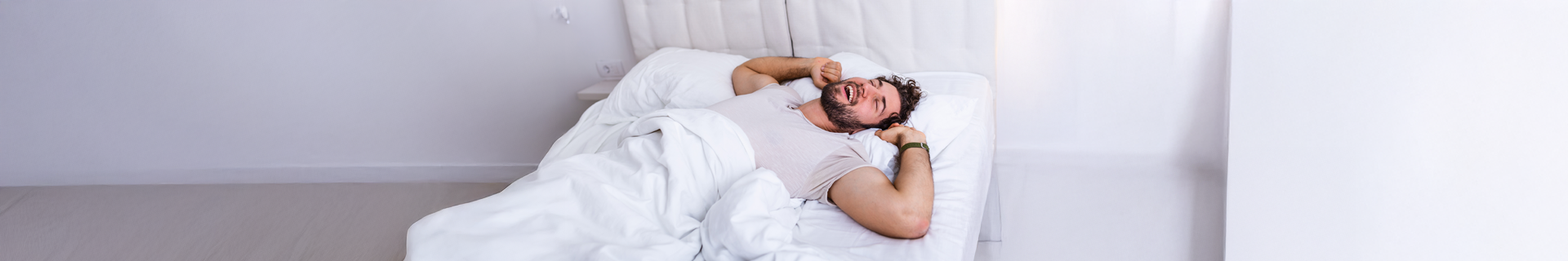 Man waking up after a good nights sleep